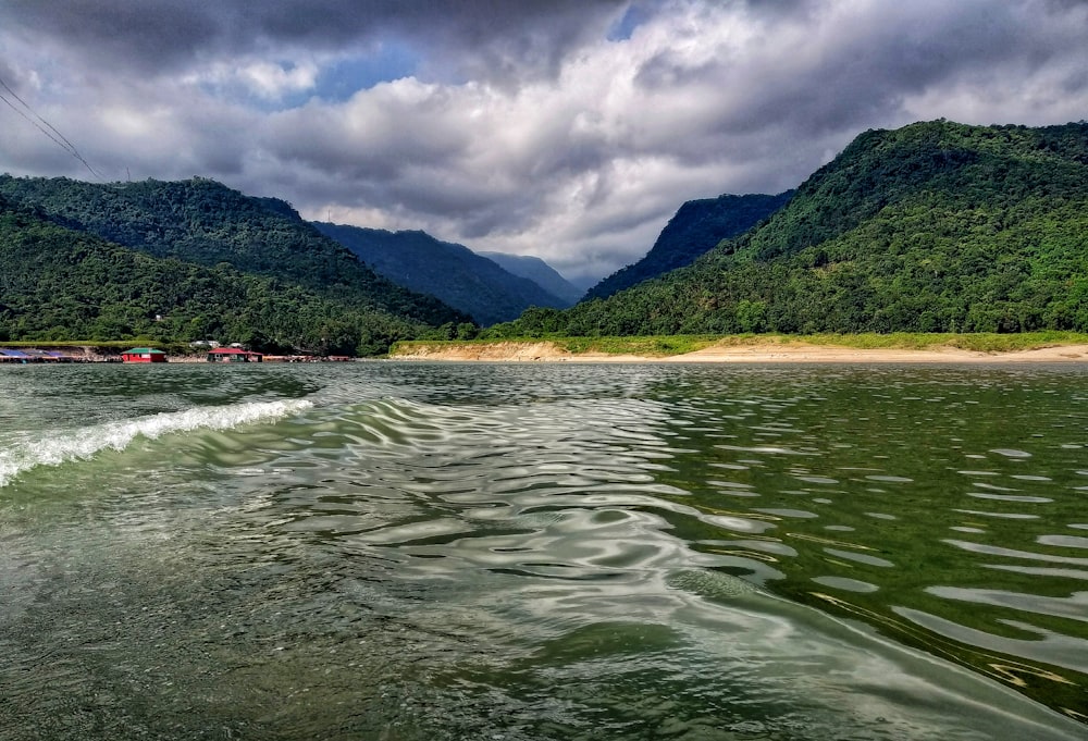 a body of water with mountains in the background