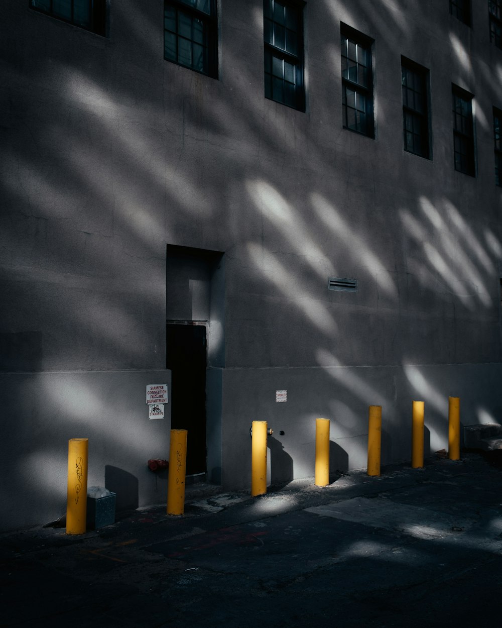 a sombra de um edifício ao lado de uma rua