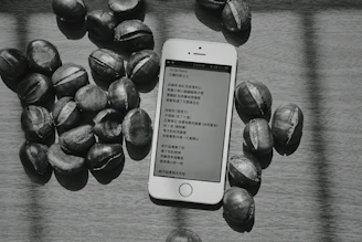 a cell phone sitting on top of a table next to nuts