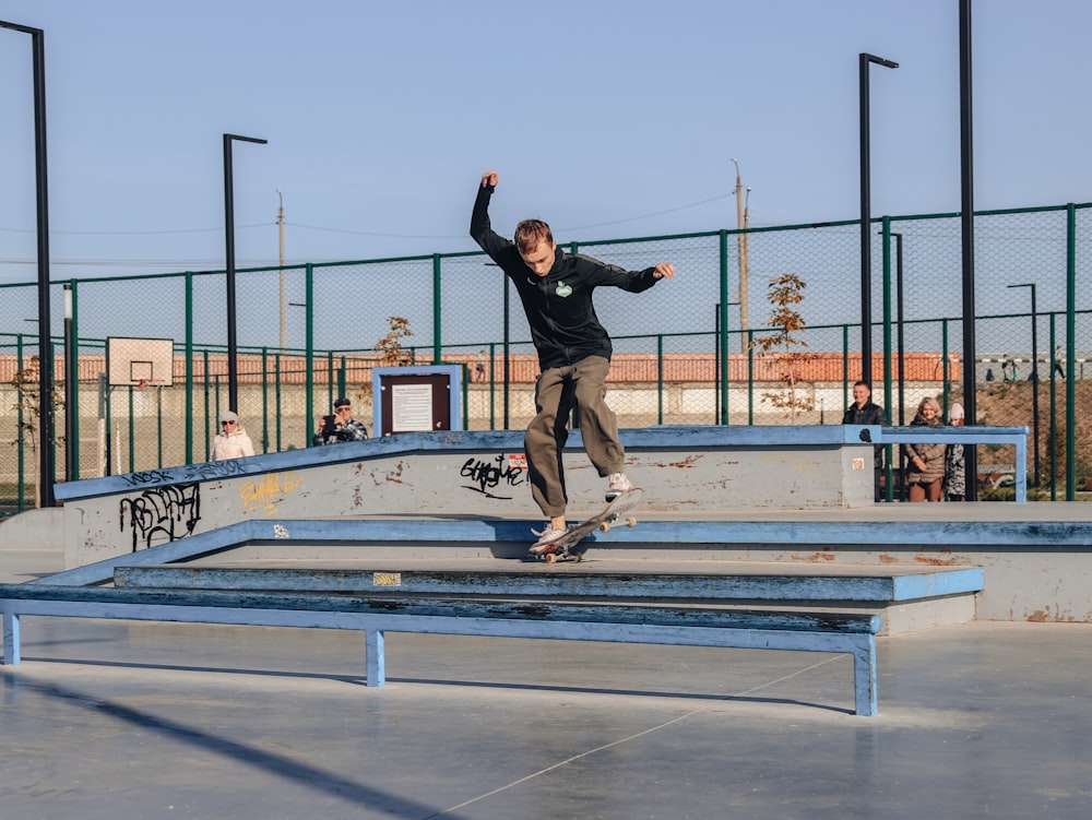 a man riding a skateboard down a metal rail