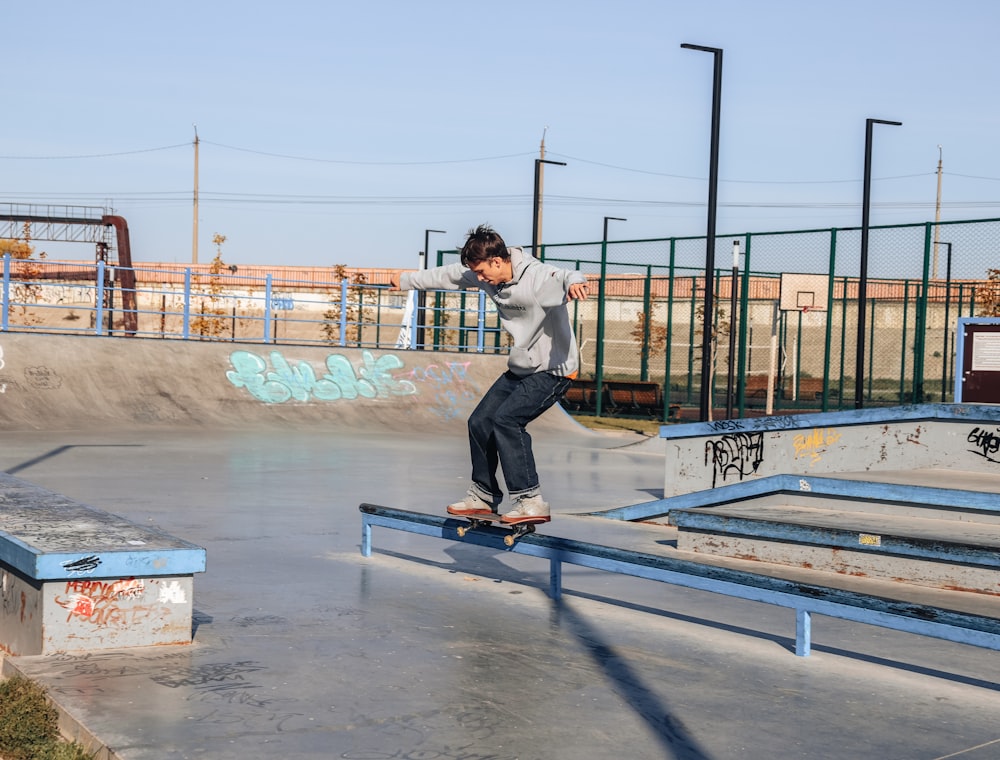 a man riding a skateboard down a metal rail