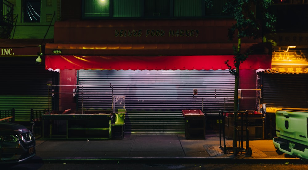 a building with a red awning at night