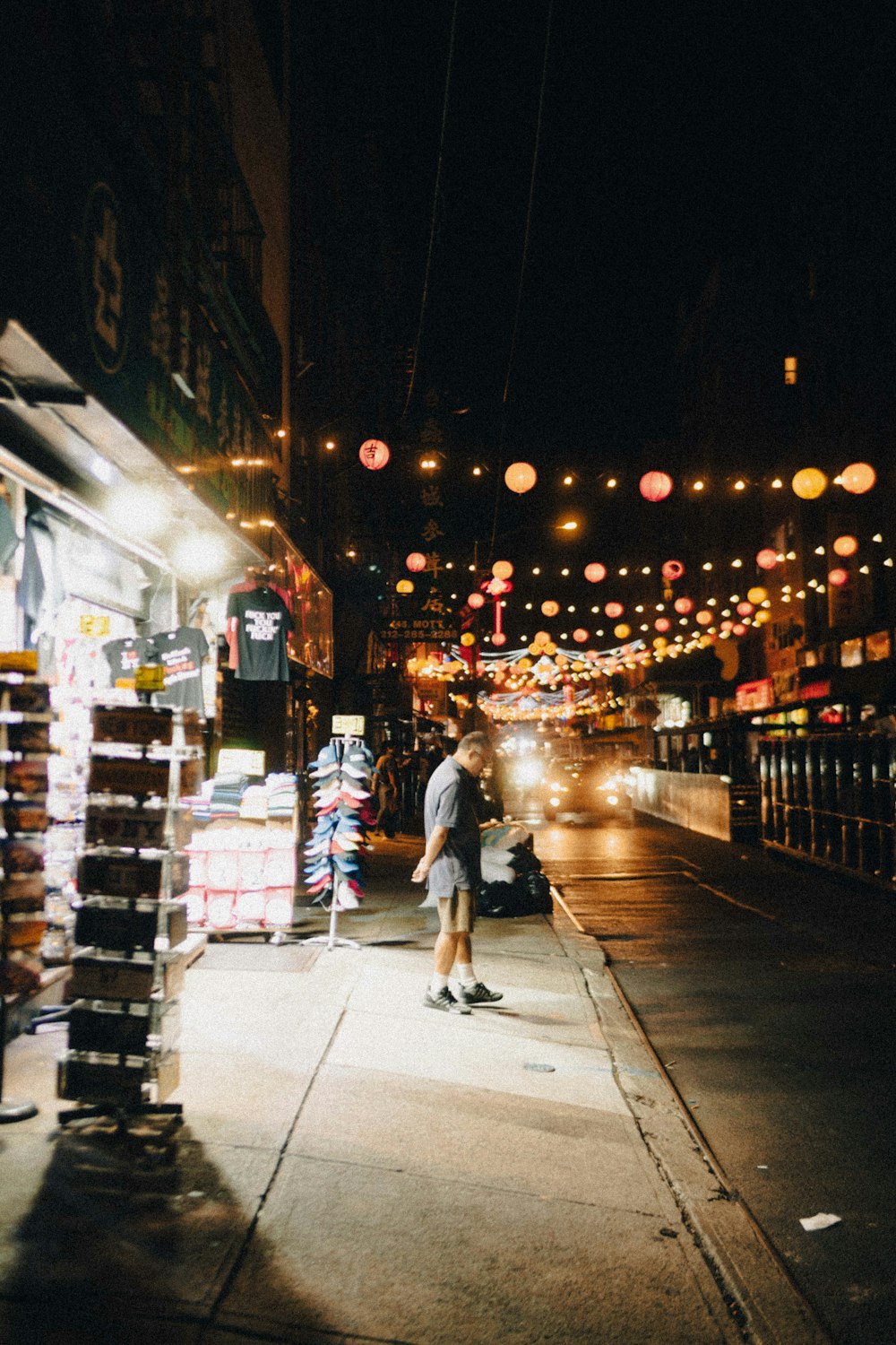 a man walking down a street at night