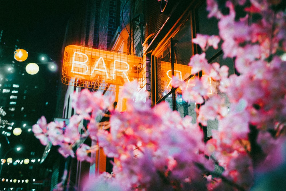 a close up of a neon sign on a building