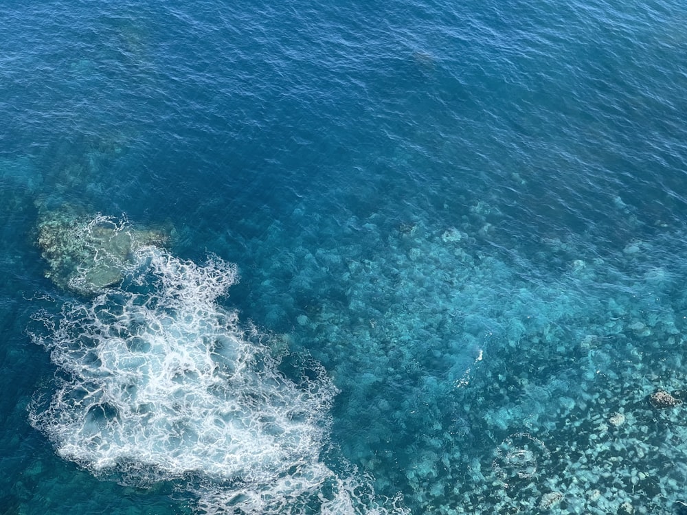 a large body of water surrounded by rocks and corals