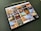 A tablet displaying a collection of interior design photos, showcasing rooms bathed in warm sunlight. The images feature modern, stylish living spaces with large windows, cozy seating, and decorative elements.