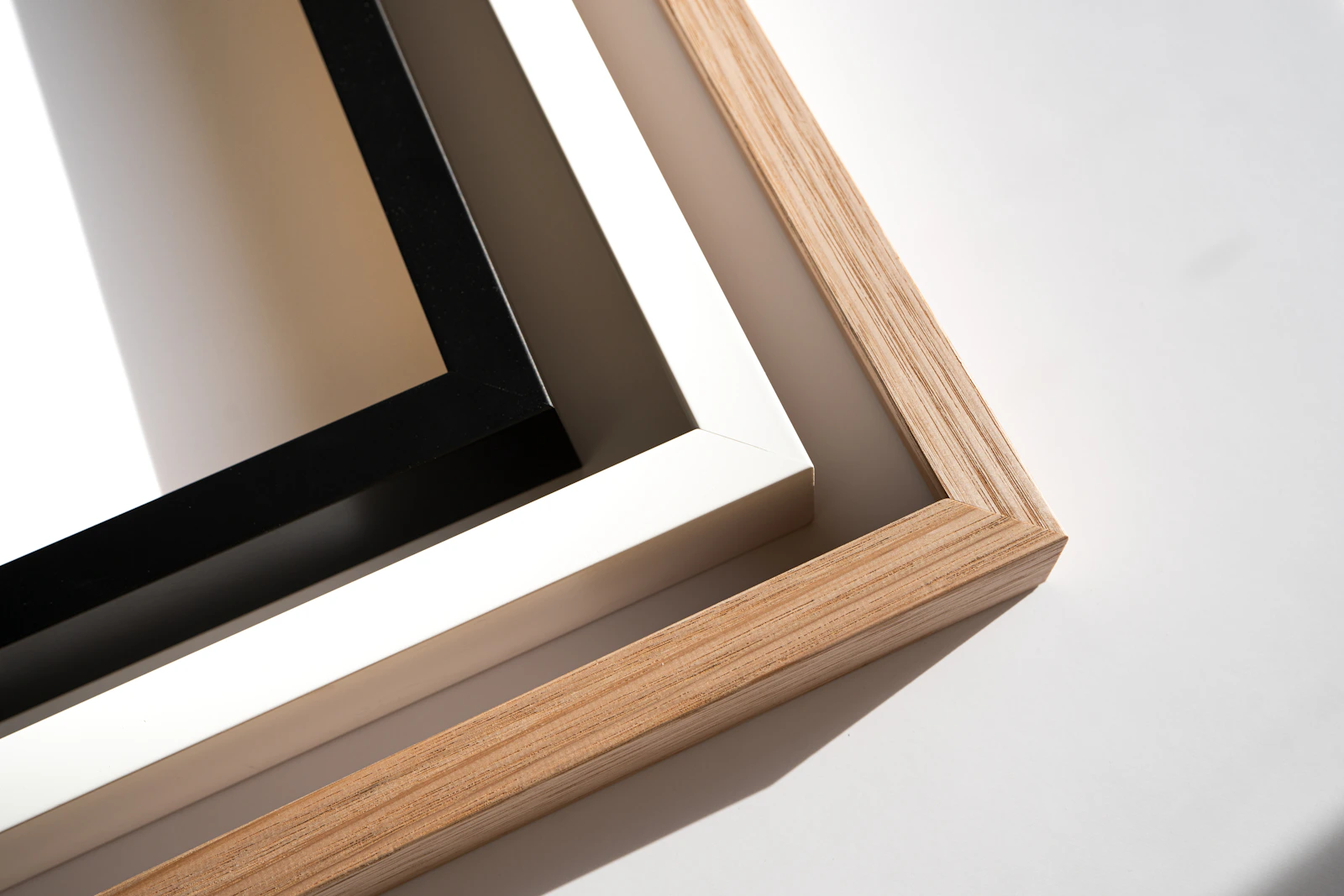 Close detail of oak, white and black picture-frame corners
