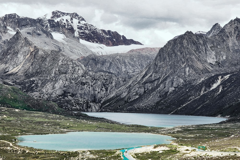 a mountain range with a lake in the foreground