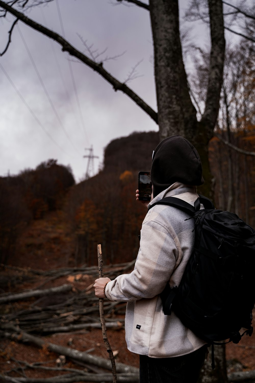 a person with a backpack and a cell phone