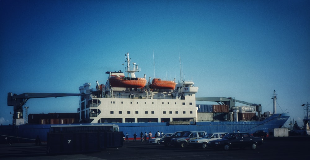 a large white boat sitting next to a loading dock