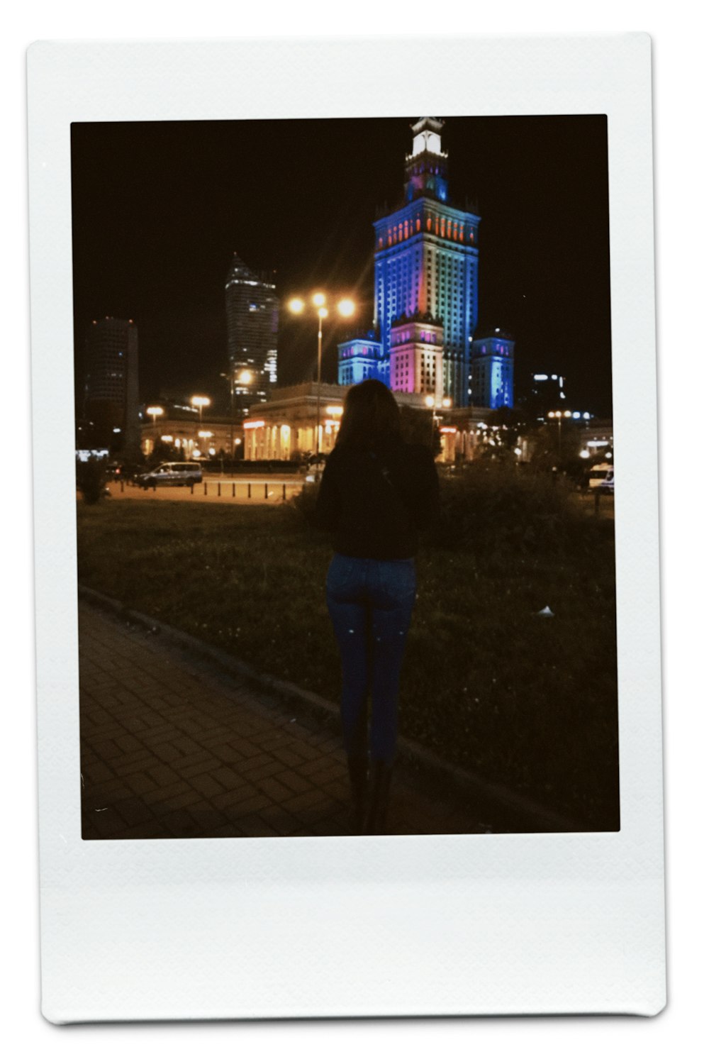 a person standing in front of a building at night