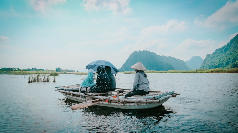 two people sitting on a small boat in the water