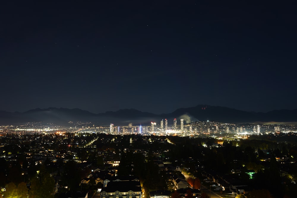 a view of a city at night from a hill