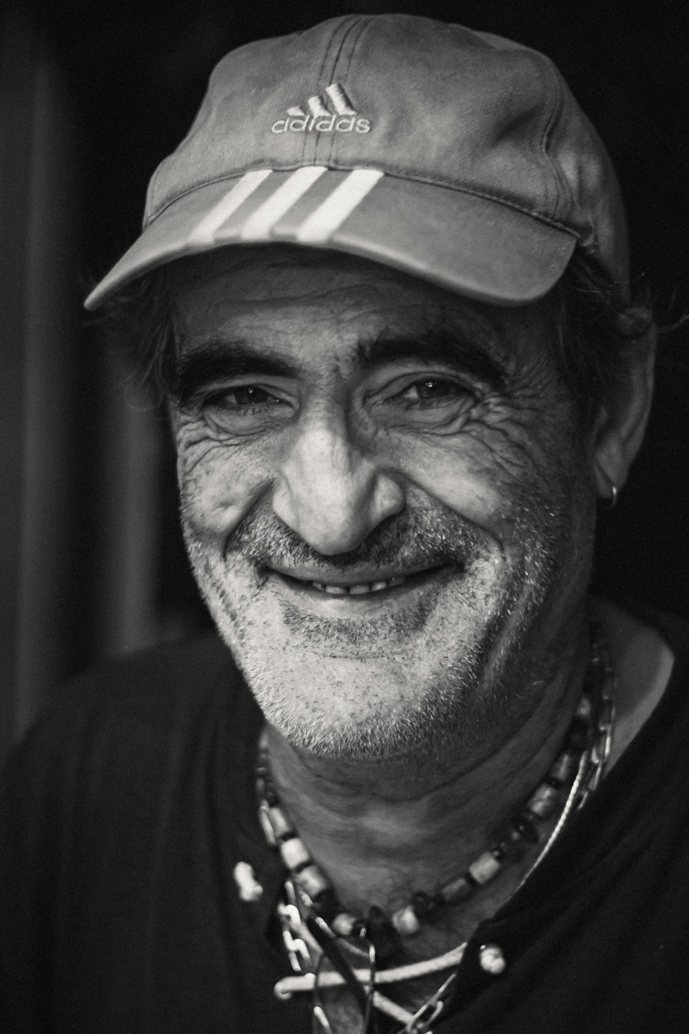 a black and white photo of a man wearing a hat