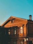 a wooden building with a clock on the top of it
