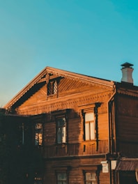 a wooden building with a clock on the top of it