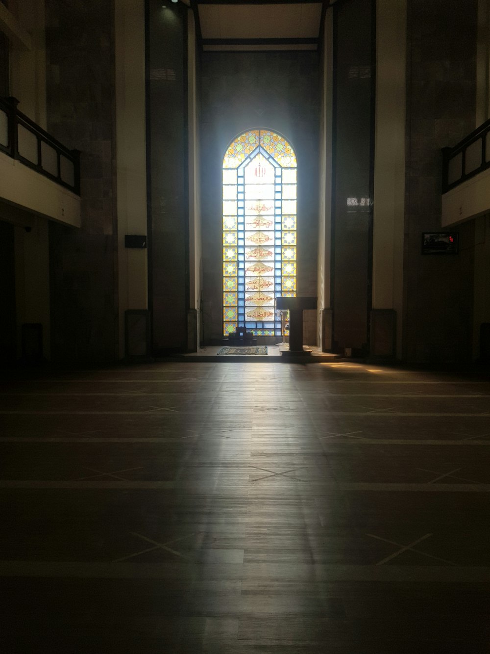 an empty church with a stained glass window