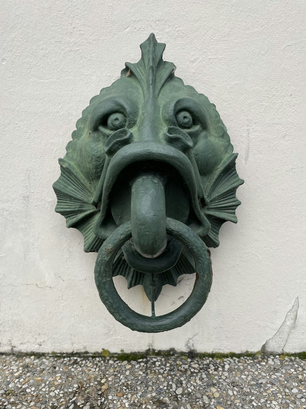 a close up of a door knockle on a wall