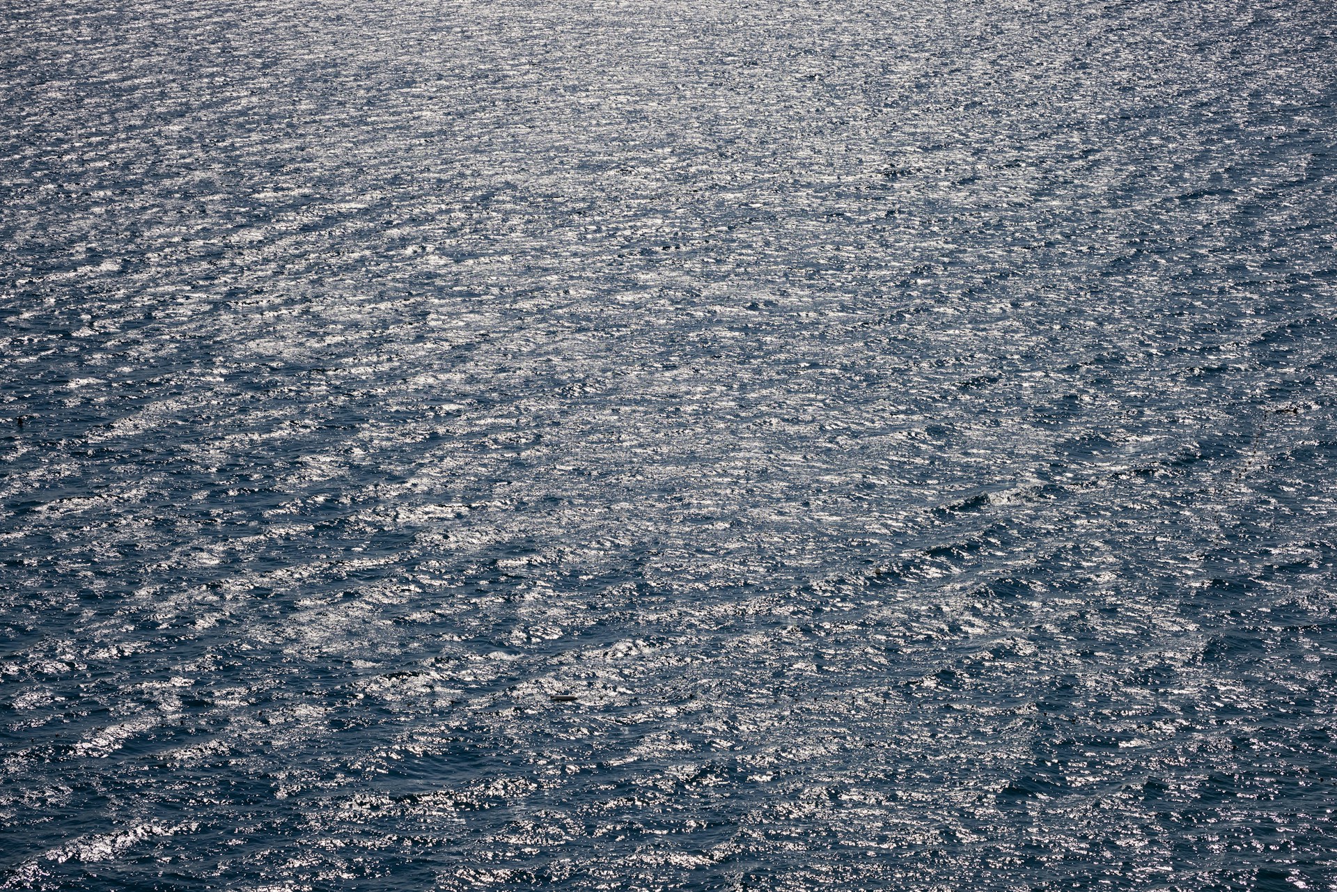 a large body of water with a boat in the distance
