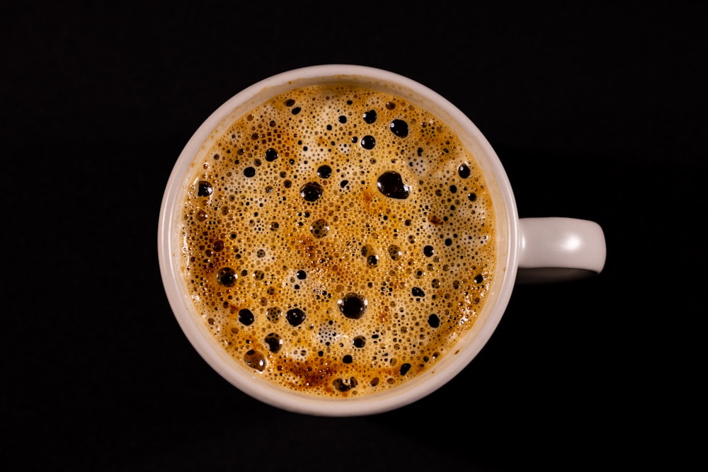 a cup of coffee on a black table