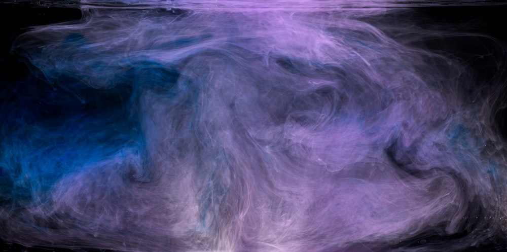 a blue and purple abstract painting on a black background