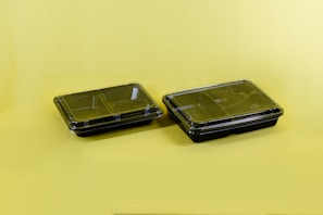 A side-by-side comparison of fresh ingredients and stored meals in silicone trays.