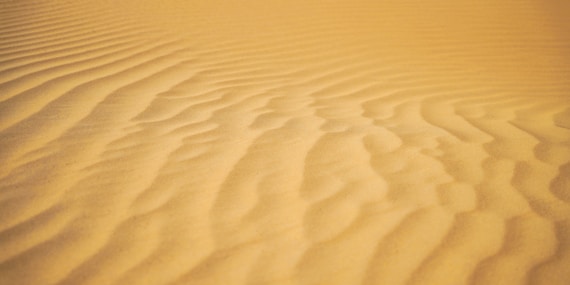a sandy area with a few lines in the sand