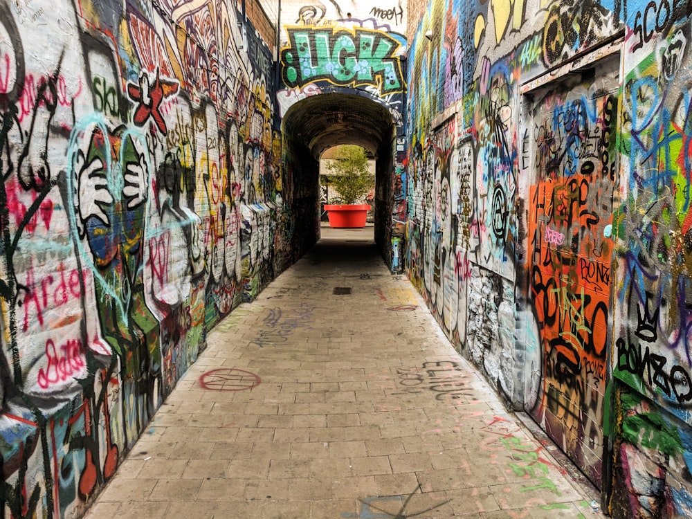 a tunnel with graffiti all over it