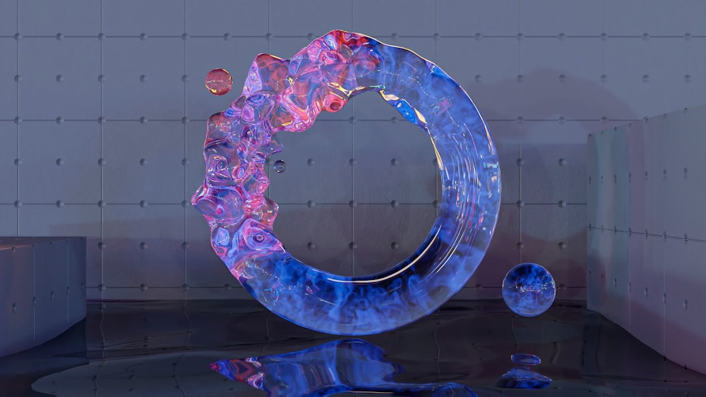 a sculpture of a circular object on a reflective surface