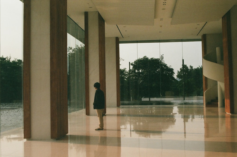 a person standing in a large room with columns