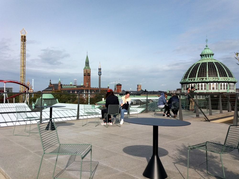 a group of people standing on top of a roof