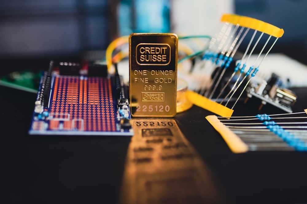 a gold bar sitting on top of a circuit board