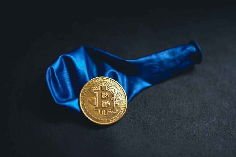 a bitcoin is sitting on a blue cloth
