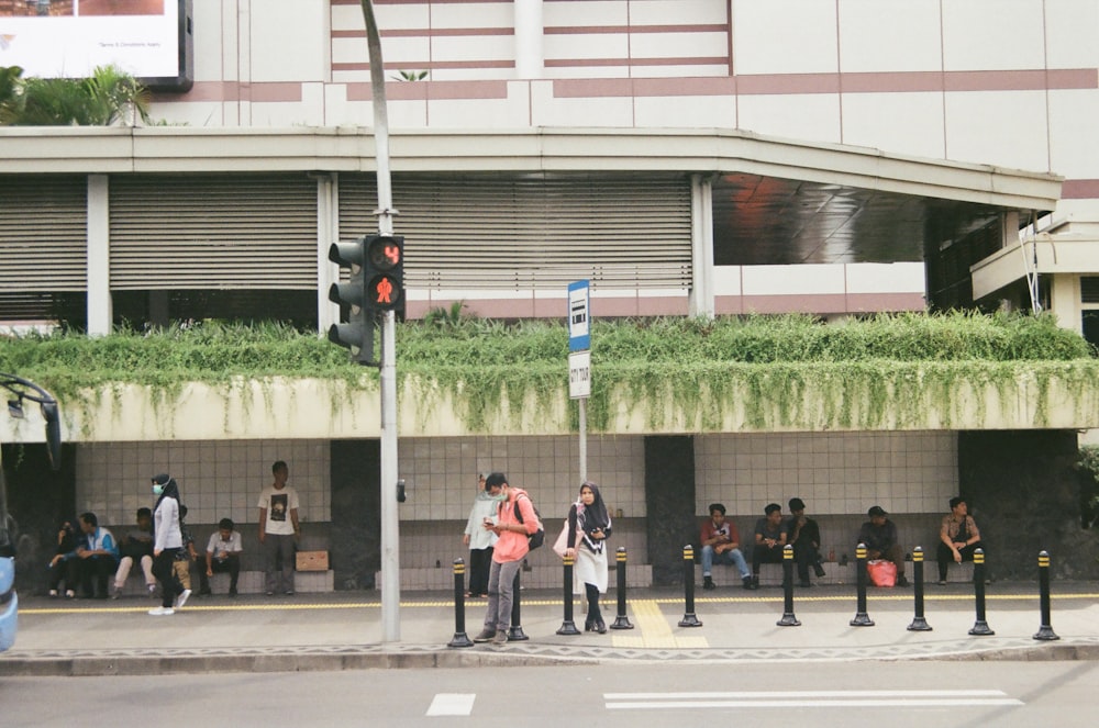 a group of people standing on the side of a road