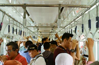 a group of people riding on a subway train