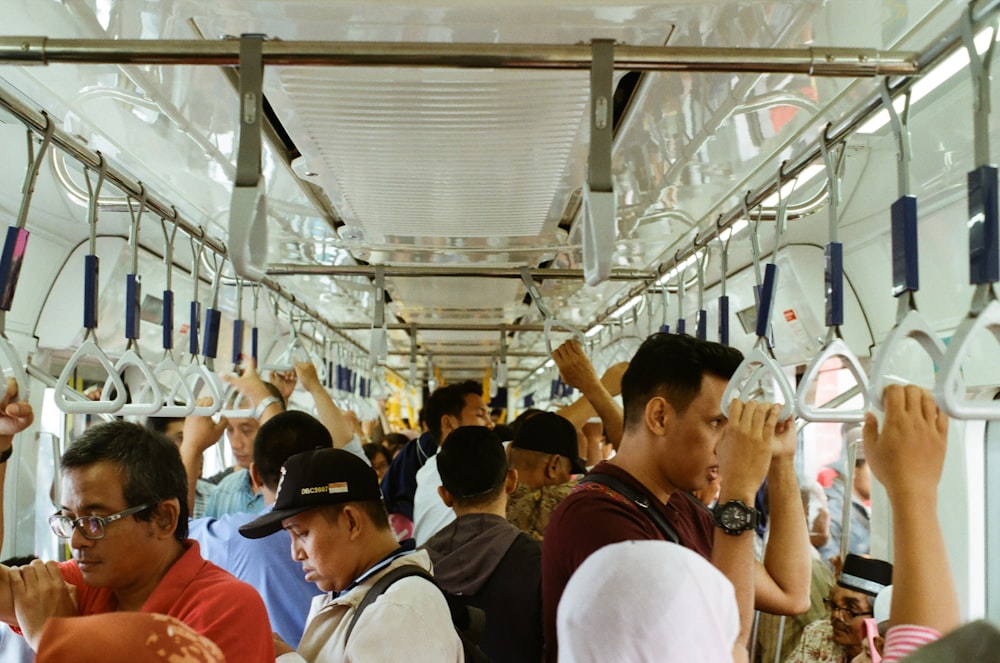 a group of people riding on a subway train