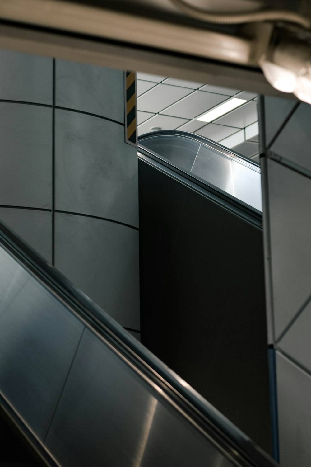 an escalator and a mirror in a building