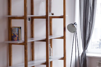 A handyman assembling a wooden bookshelf in a bright Marseille apartment
