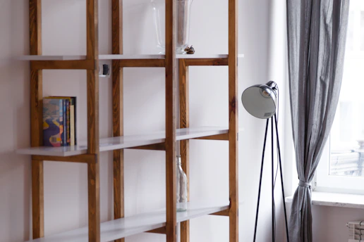 A handyman assembling a wooden bookshelf in a bright Marseille apartment