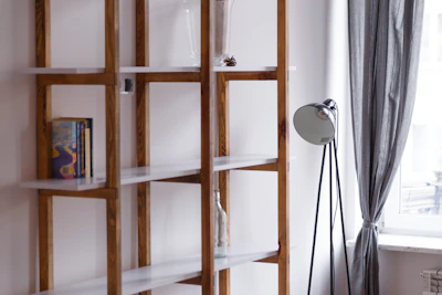A completed IKEA bookshelf standing against a bright wall.
