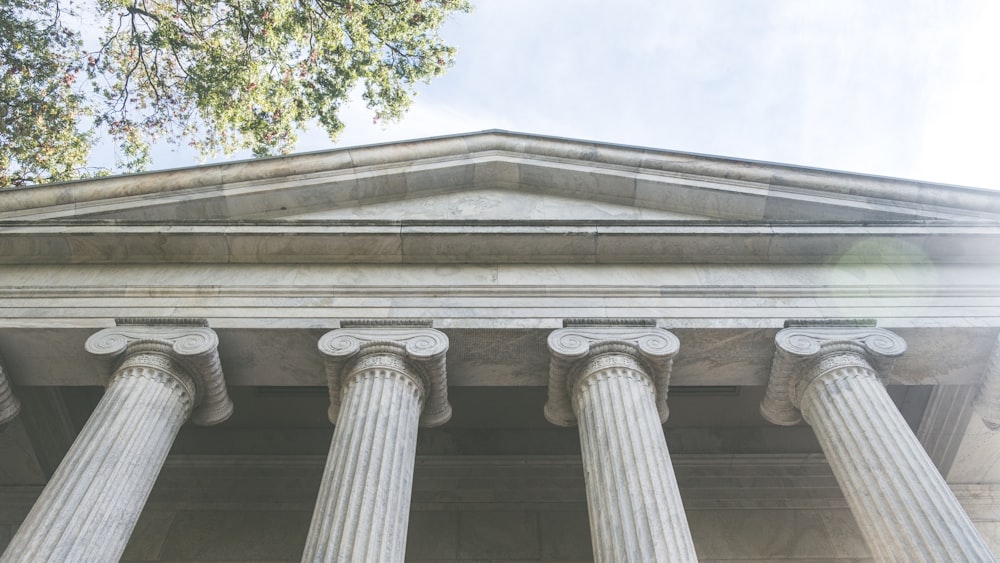 a close up of the top of a building with columns