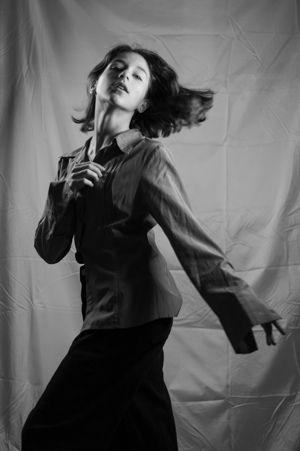 a woman standing in front of a white backdrop