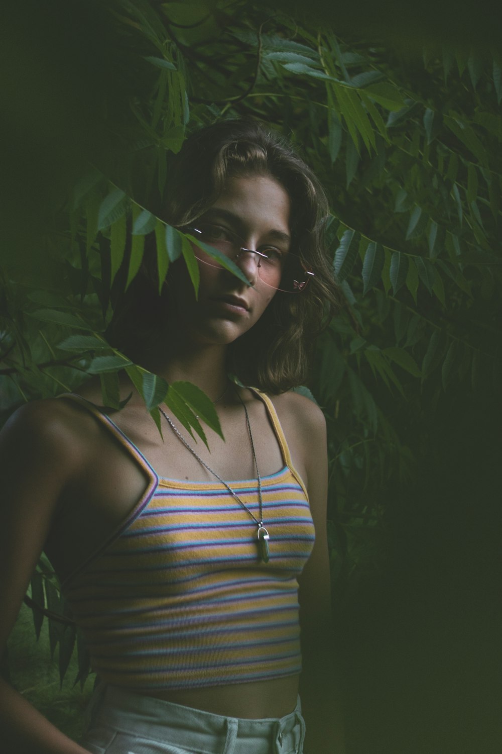 a woman wearing glasses and a striped shirt