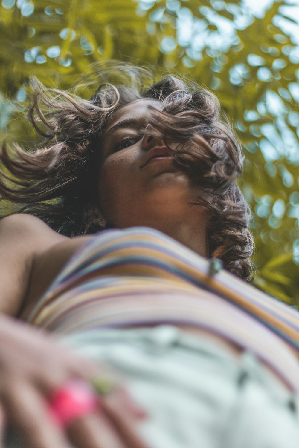 a woman laying in a hammock with her eyes closed