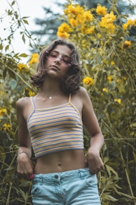 a woman standing in front of a field of flowers