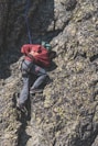 a man climbing up the side of a mountain