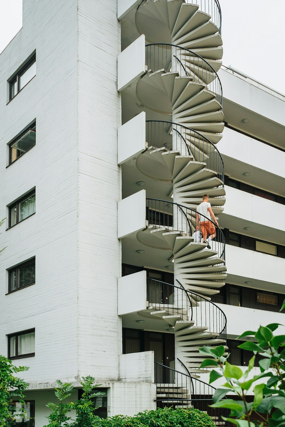 a spiral staircase in front of a white building