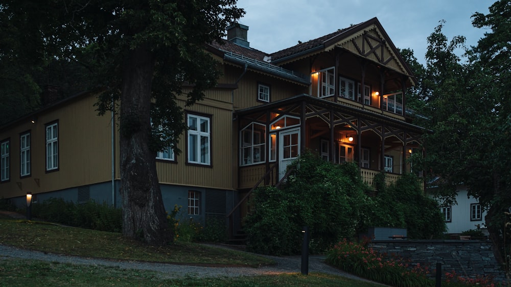 a large brown house with a lot of windows