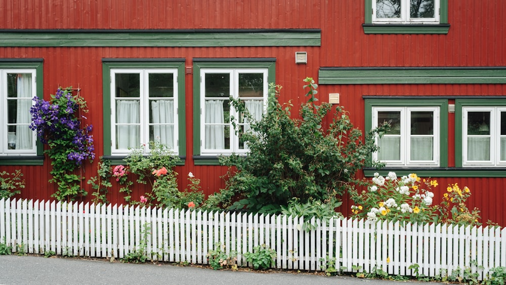 a red house with a white picket fence