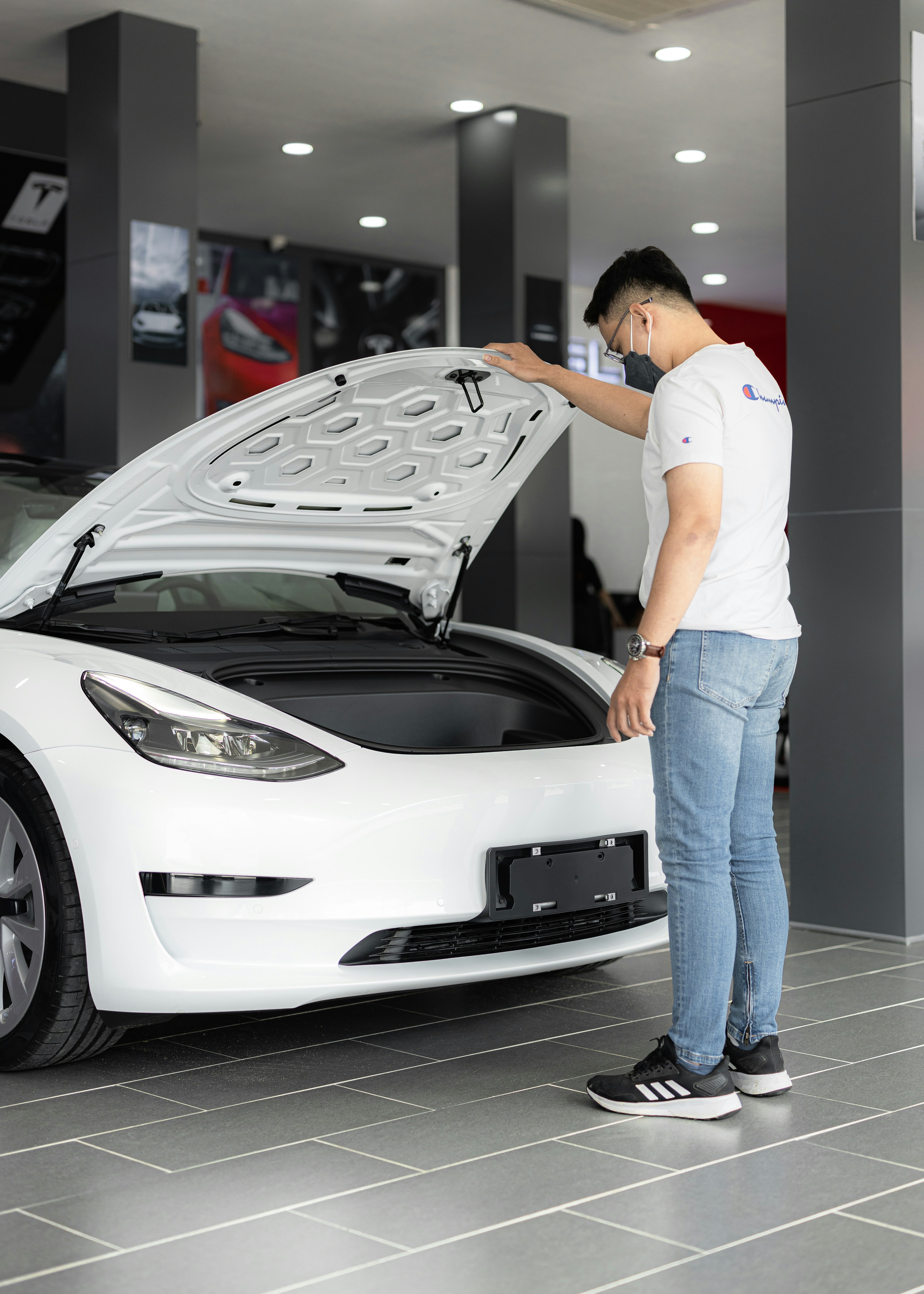 a man looking under the hood of a car